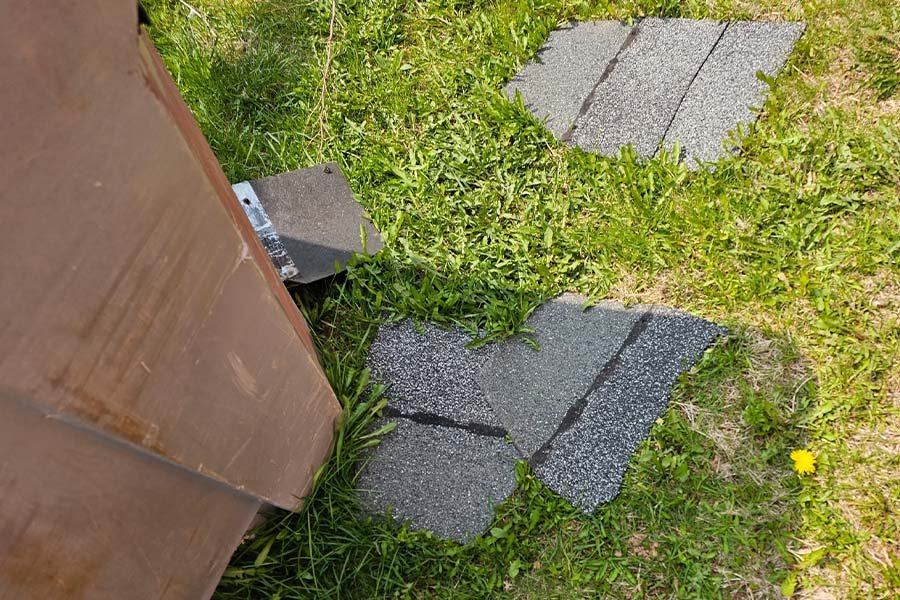 Missing Roof Shingles in Yard